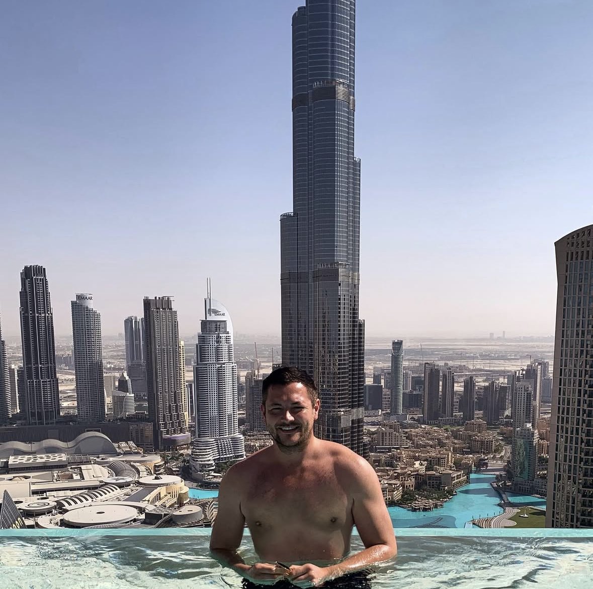 Nick in a rooftop pool in Dubai with the Burj Khalifa behind